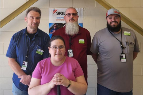 Envision Xpress Hires New Cashier/Stocker at Whiteman Air Force Base Cassandra Leaman standing with her new coworkers, smiling at the camera.
